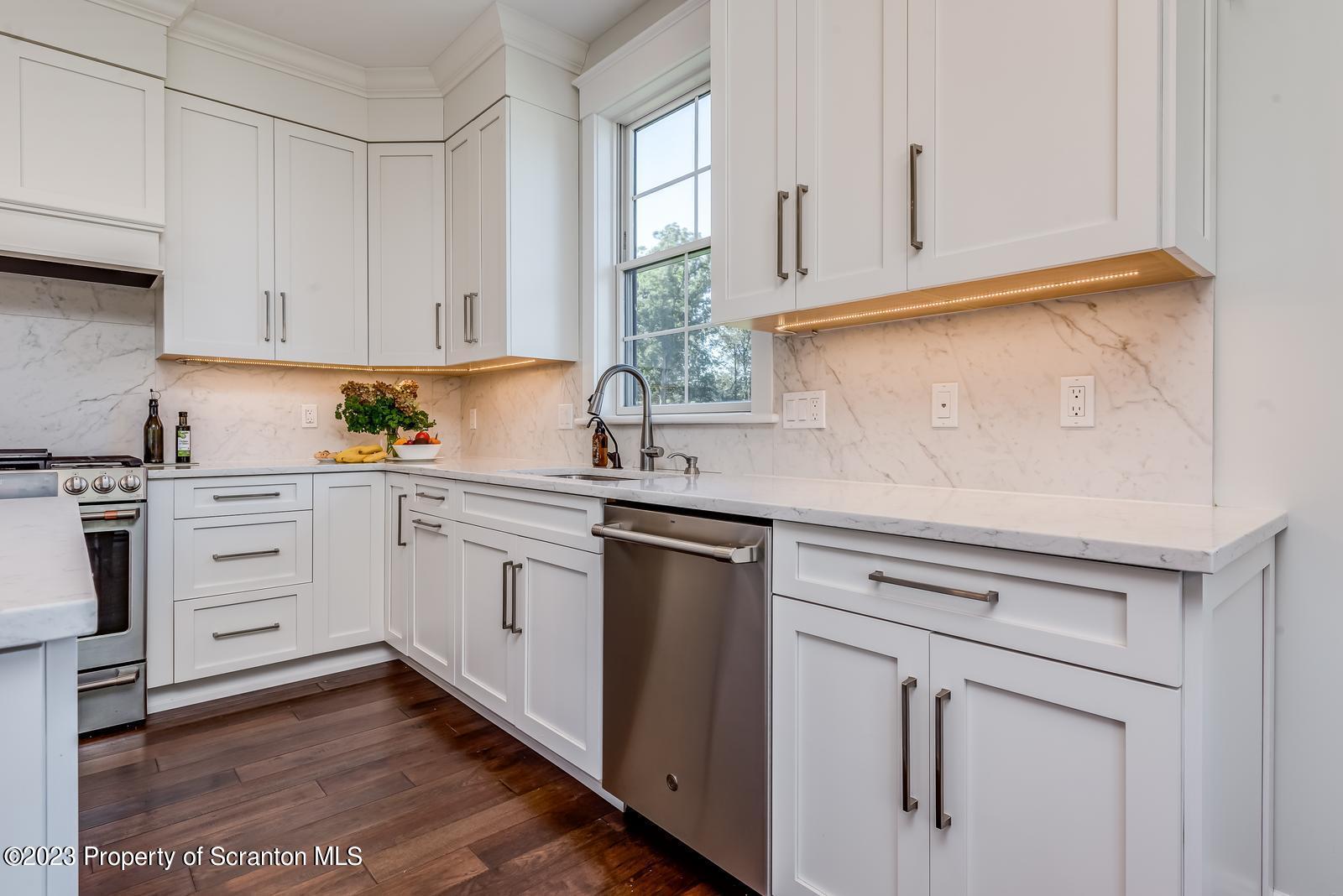 115 Rock Ridge Drive Clarks Summit, PA 18411 - Photo 17 of 43 a kitchen with white cabinets and white appliances