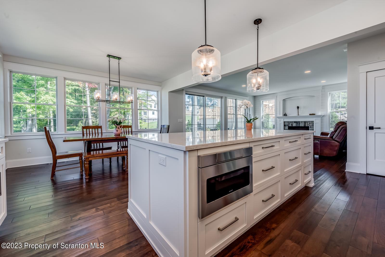 115 Rock Ridge Drive Clarks Summit, PA 18411 - Photo 19 of 43 a kitchen with stainless steel appliances granite countertop a stove a sink a island and chairs