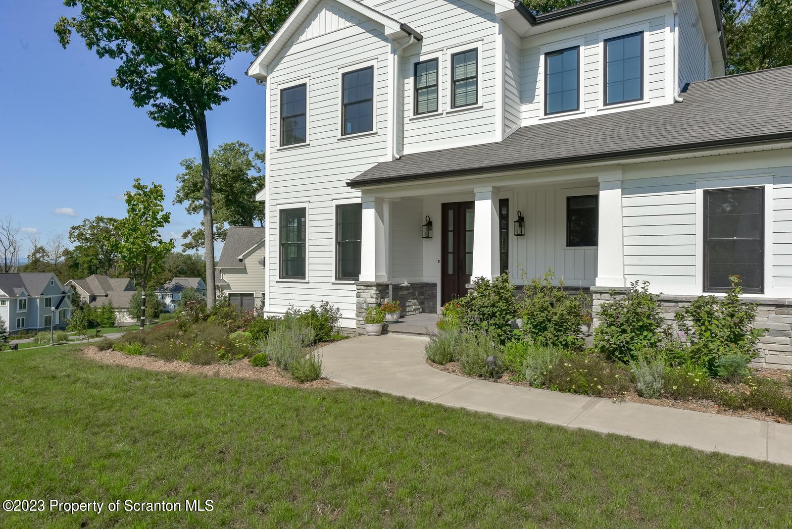 115 Rock Ridge Drive Clarks Summit, PA 18411 - Photo 2 of 43 a front view of a house with a garden