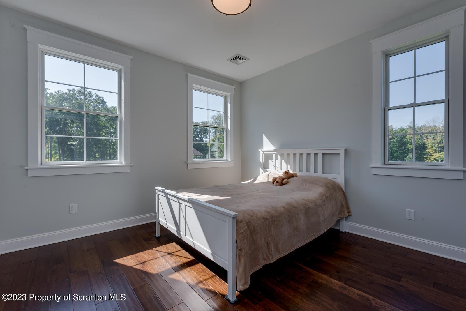 115 Rock Ridge Drive Clarks Summit, PA 18411 - Photo 21 of 43 a bed sitting in a bedroom next to a window