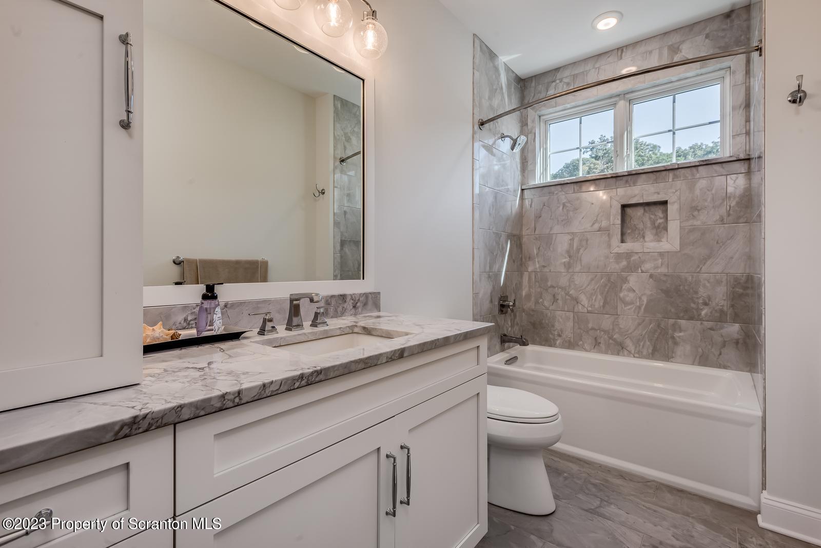 115 Rock Ridge Drive Clarks Summit, PA 18411 - Photo 24 of 43 a bathroom with a granite countertop sink a toilet and shower