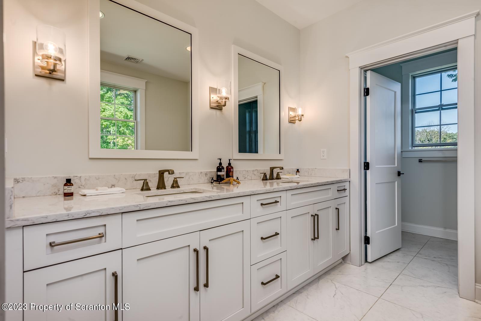 115 Rock Ridge Drive Clarks Summit, PA 18411 - Photo 27 of 43 a bathroom with double sink and a mirror
