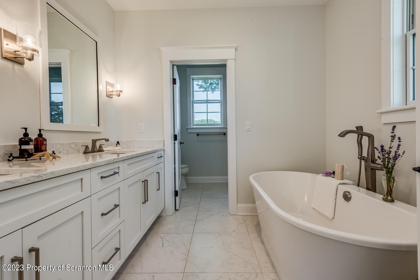 115 Rock Ridge Drive Clarks Summit, PA 18411 - Photo 28 of 43 a bathroom with a bathtub sink and mirror