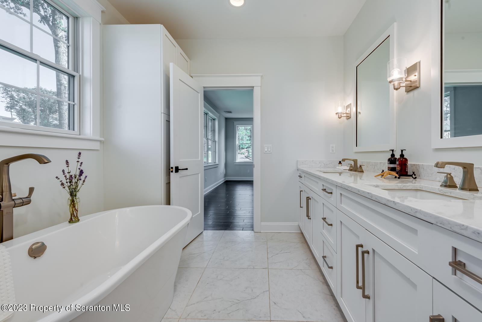 115 Rock Ridge Drive Clarks Summit, PA 18411 - Photo 30 of 43 a bathroom with a tub sink and mirror
