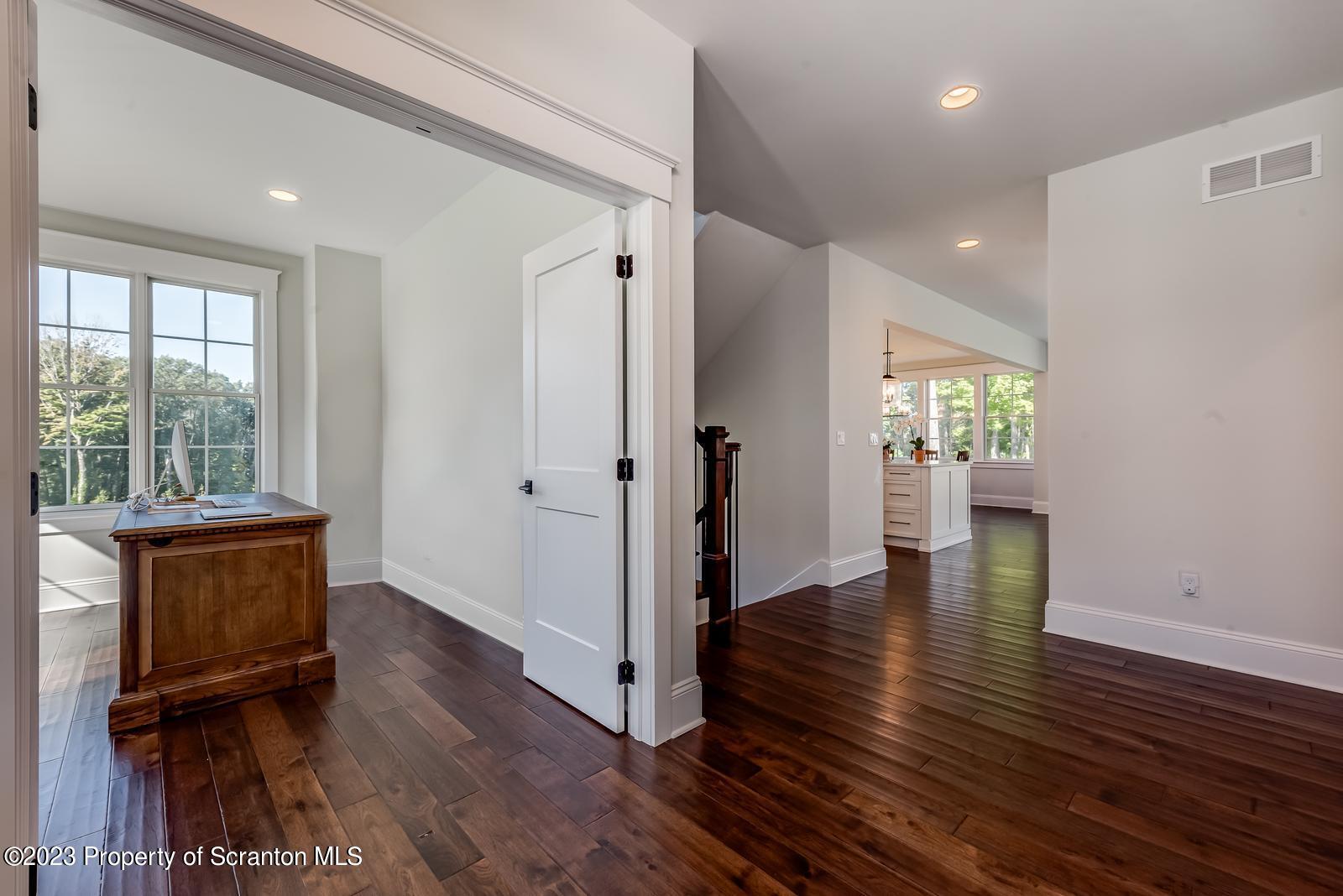 115 Rock Ridge Drive Clarks Summit, PA 18411 - Photo 3 of 43 a view of a hallway with wooden floor and windows