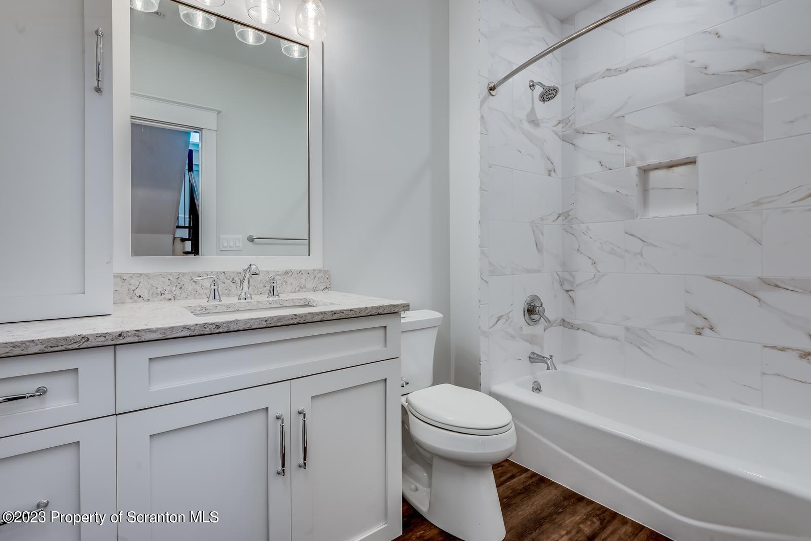 115 Rock Ridge Drive Clarks Summit, PA 18411 - Photo 35 of 43 a bathroom with a granite countertop sink a toilet and shower