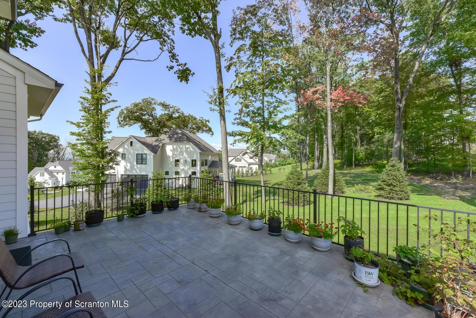 115 Rock Ridge Drive Clarks Summit, PA 18411 - Photo 37 of 43 a view of a house with a small yard and large trees