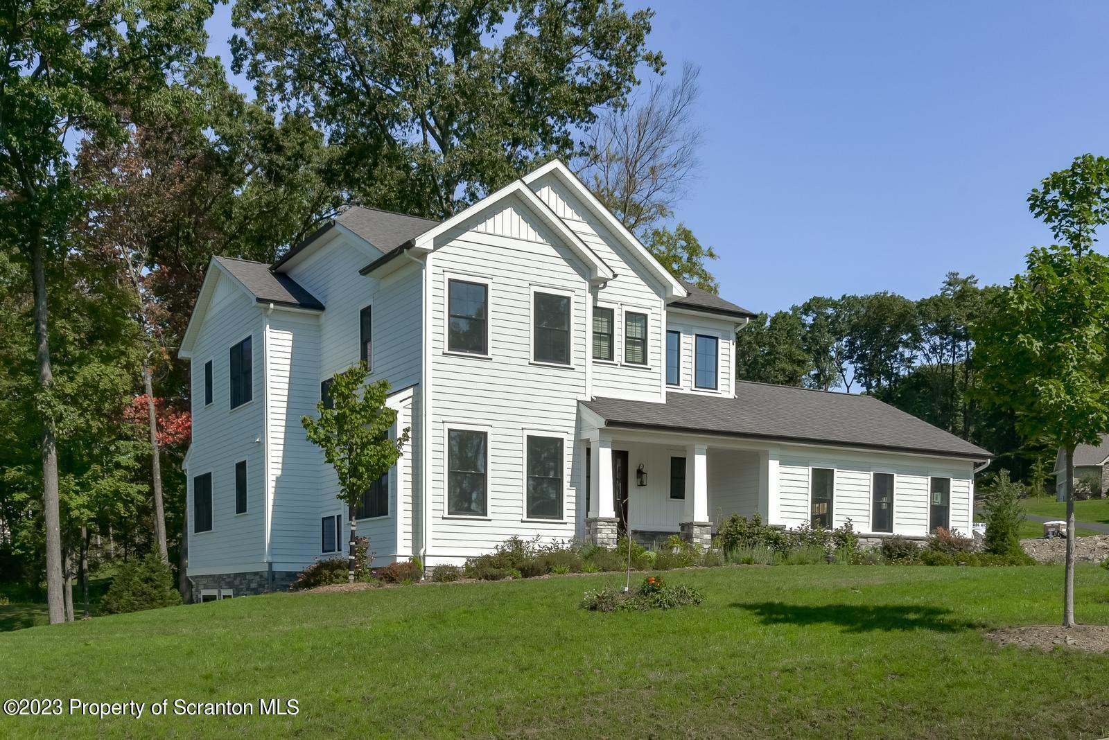 115 Rock Ridge Drive Clarks Summit, PA 18411 - Photo 40 of 43 a front view of a house with a yard