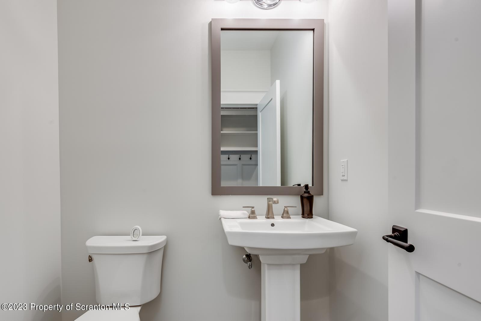 115 Rock Ridge Drive Clarks Summit, PA 18411 - Photo 7 of 43 a bathroom with a sink toilet and mirror