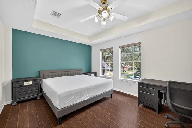 a bedroom with a bed and a desk