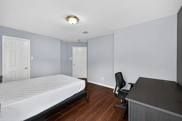 a bedroom with a bed and a desk