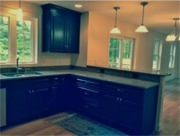 2 Coventry Road Atkinson, NH 03811 - Photo 3 of 10 a kitchen with granite countertop wooden cabinets a window and a sink