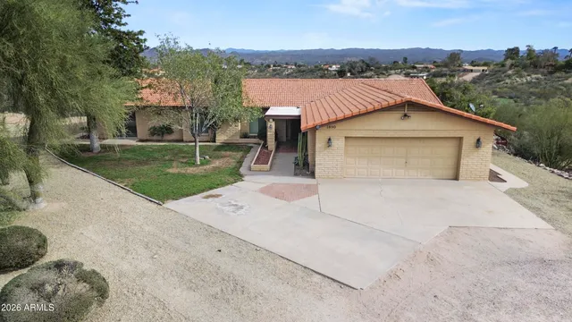 a view of a house with a yard and sitting area