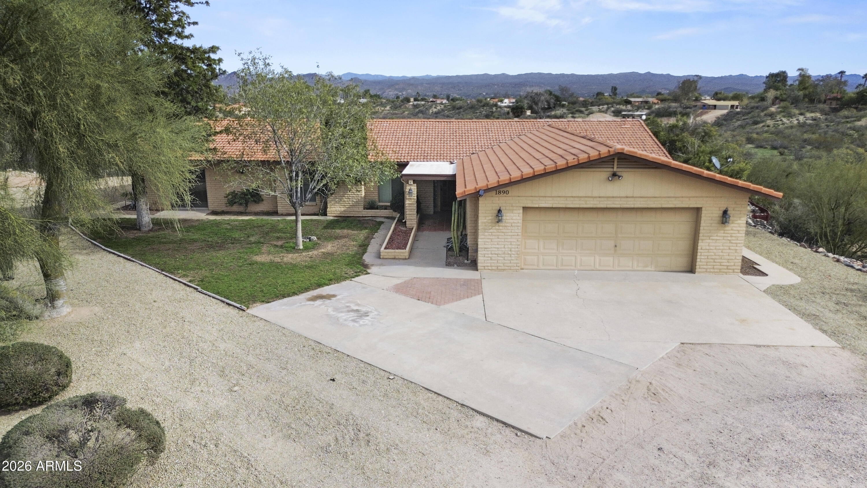 a view of a house with a yard and sitting area