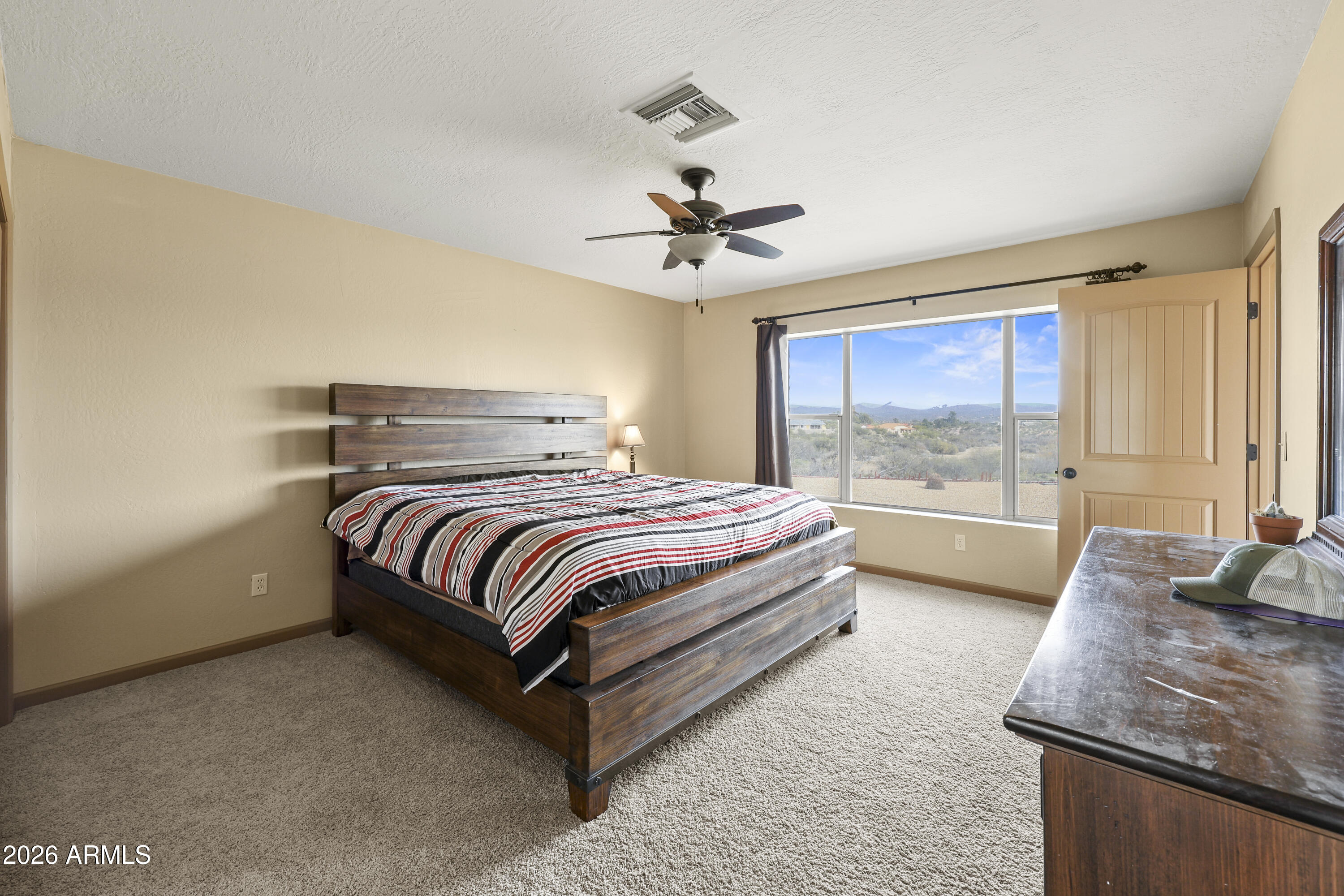 1890 West Roderick Lane Wickenburg, AZ 85390 - Photo 11 of 41 a spacious bedroom with a bed and window