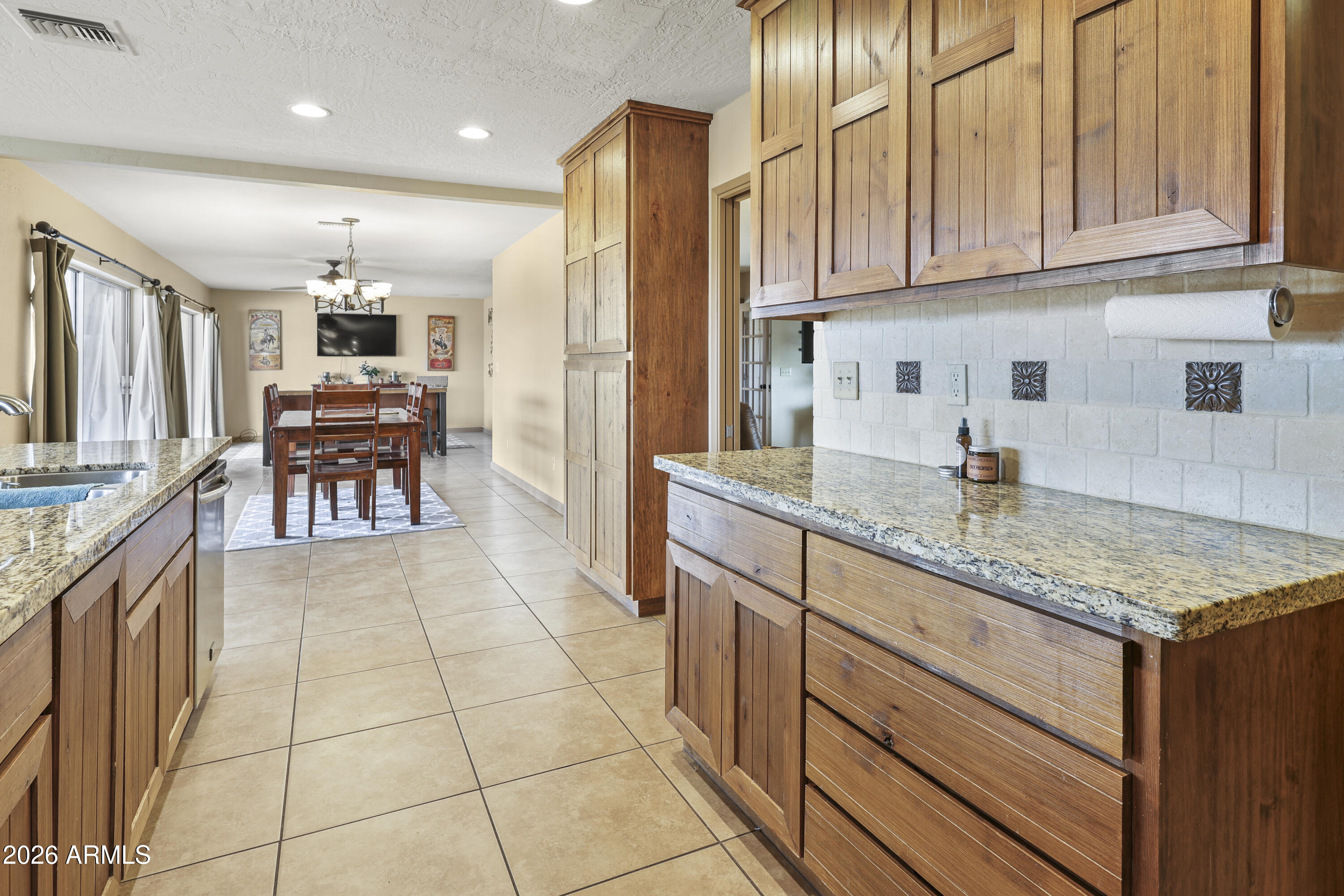 1890 West Roderick Lane Wickenburg, AZ 85390 - Photo 19 of 41 a kitchen with stainless steel appliances granite countertop a sink and cabinets