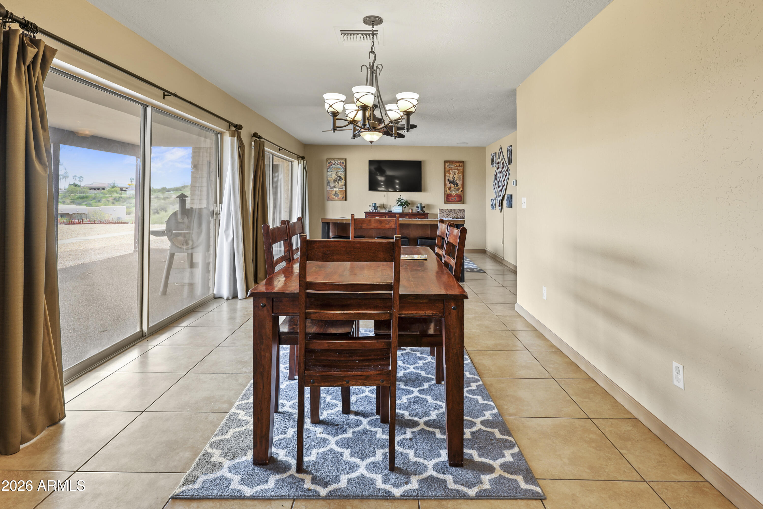 1890 West Roderick Lane Wickenburg, AZ 85390 - Photo 20 of 41 a view of a dining room with furniture a chandelier and window