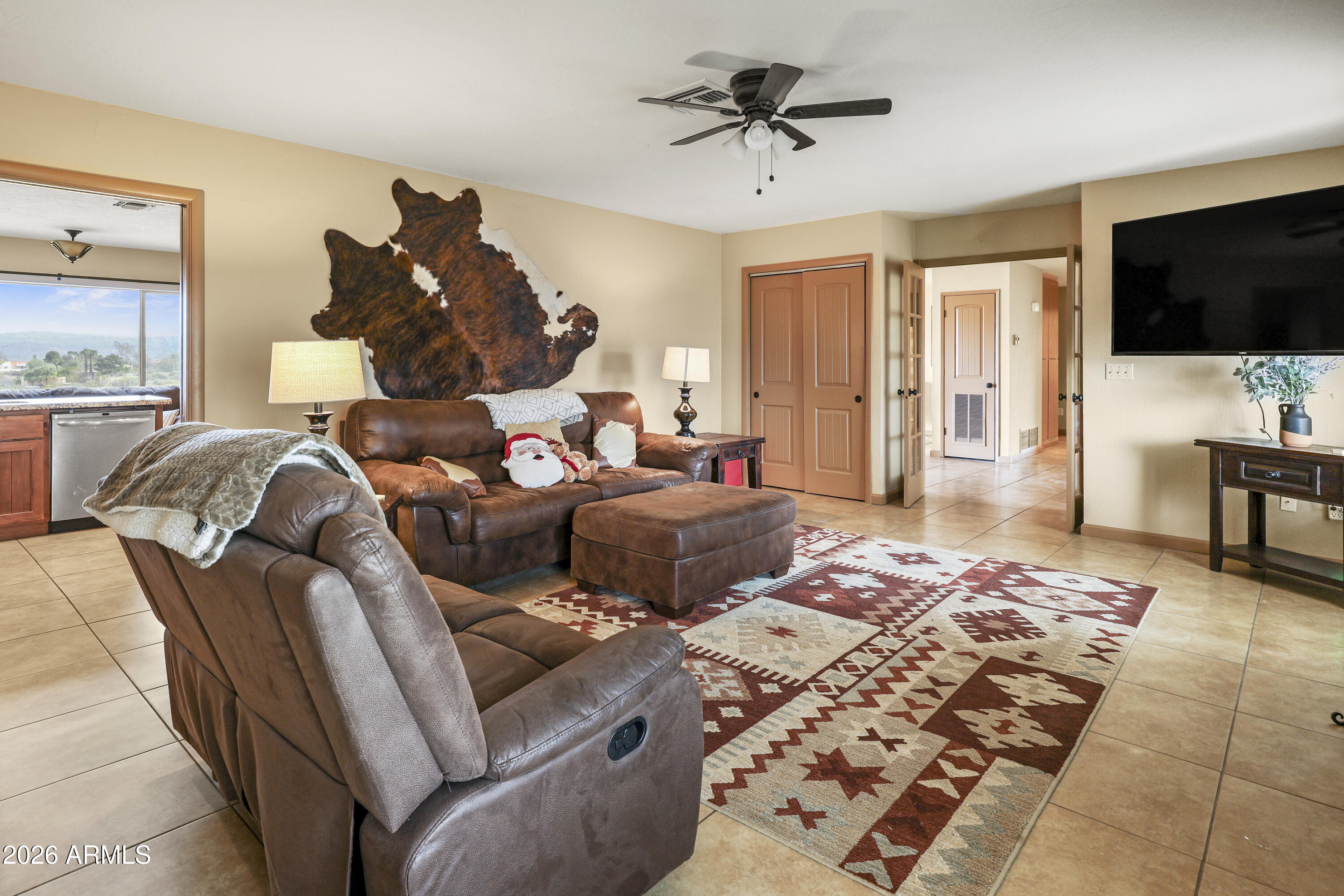 1890 West Roderick Lane Wickenburg, AZ 85390 - Photo 21 of 41 a living room with furniture and a flat screen tv