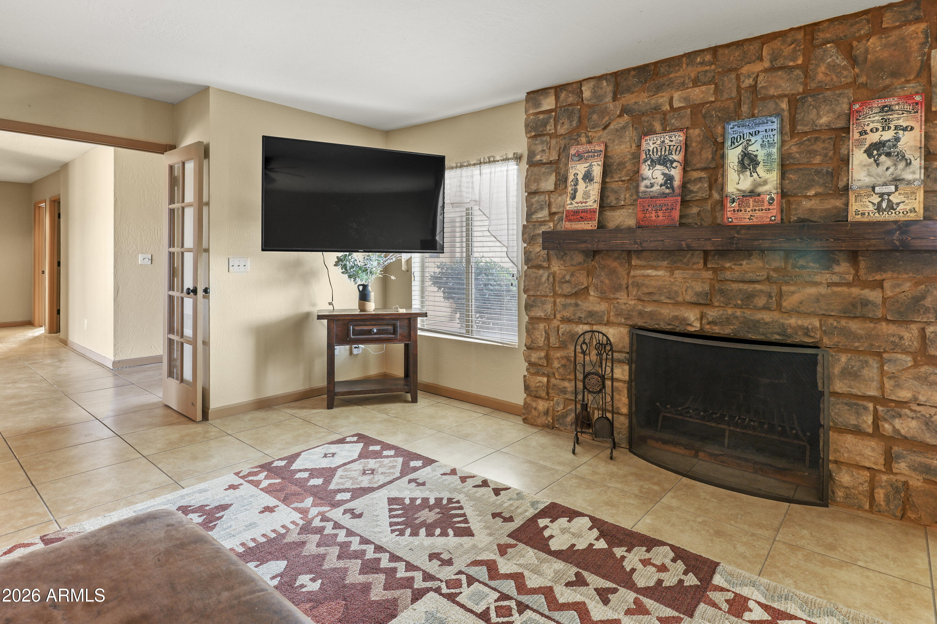 1890 West Roderick Lane Wickenburg, AZ 85390 - Photo 23 of 41 a living room with furniture a flat screen tv and a fireplace