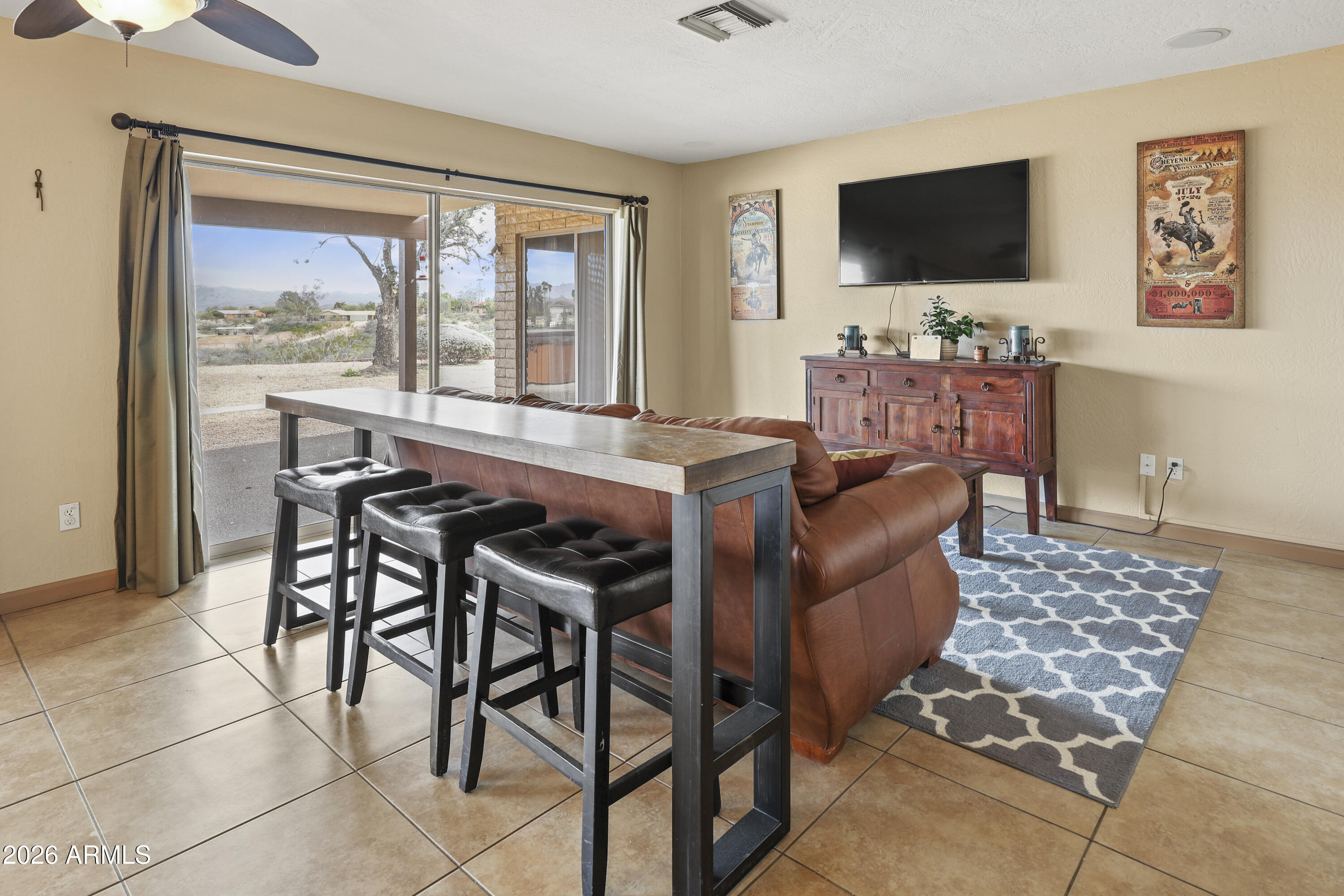 1890 West Roderick Lane Wickenburg, AZ 85390 - Photo 24 of 41 a living room with furniture and a flat screen tv