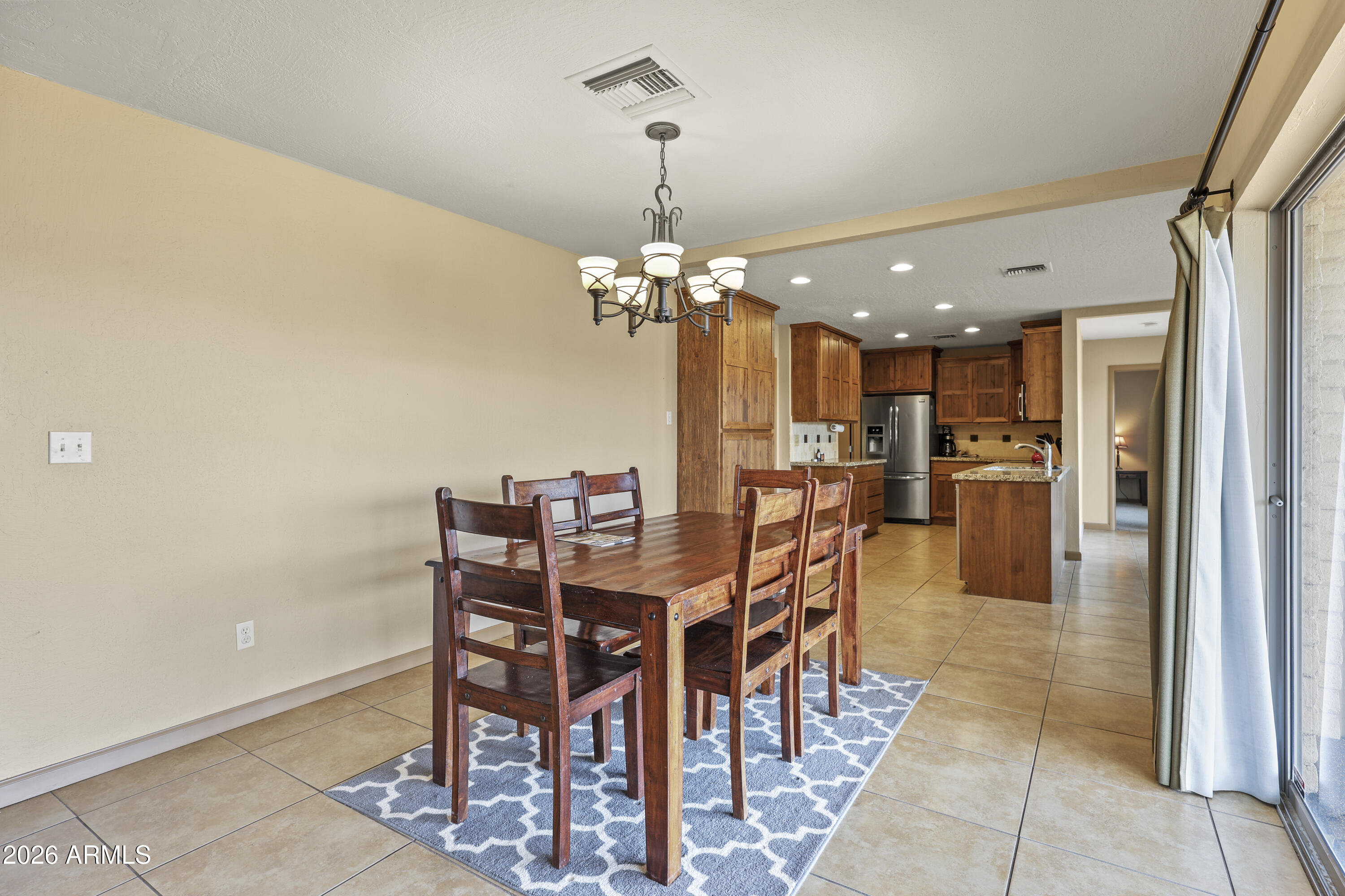 1890 West Roderick Lane Wickenburg, AZ 85390 - Photo 26 of 41 a view of a dining room with furniture and chandelier