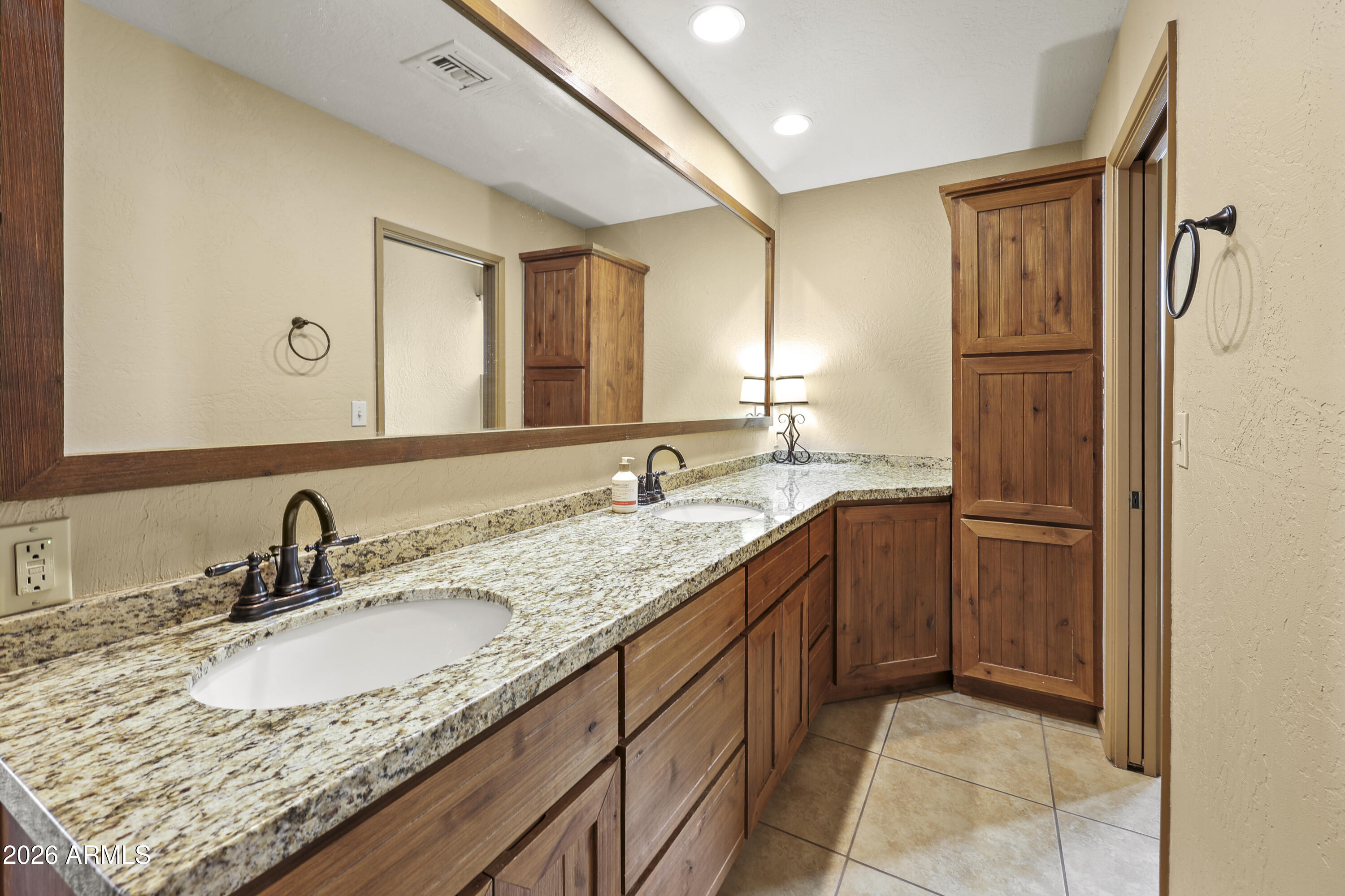 1890 West Roderick Lane Wickenburg, AZ 85390 - Photo 3 of 41 a bathroom with a granite countertop double vanity sink and mirror