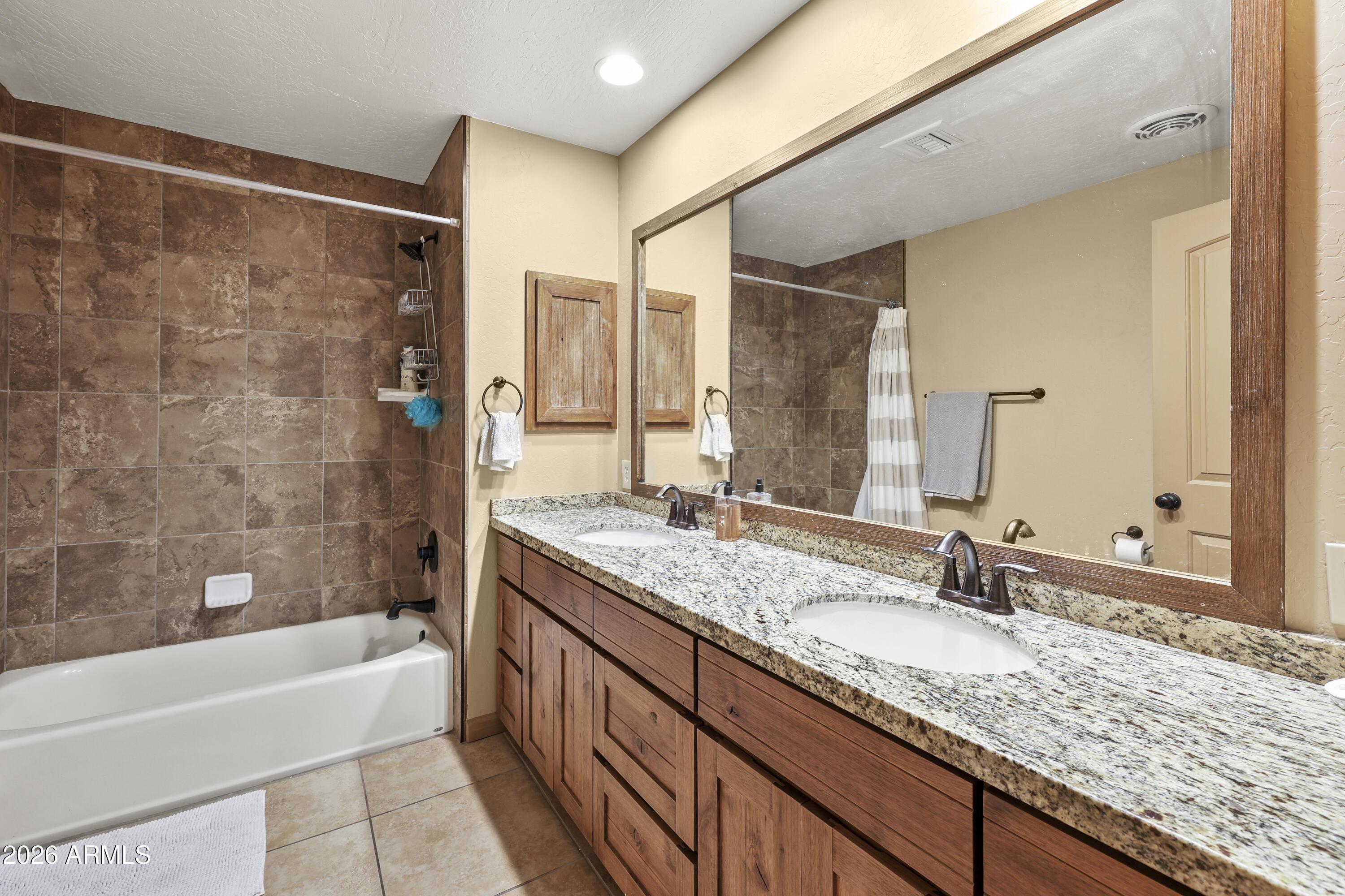 1890 West Roderick Lane Wickenburg, AZ 85390 - Photo 31 of 41 a bathroom with a granite countertop sink mirror and a bath tub