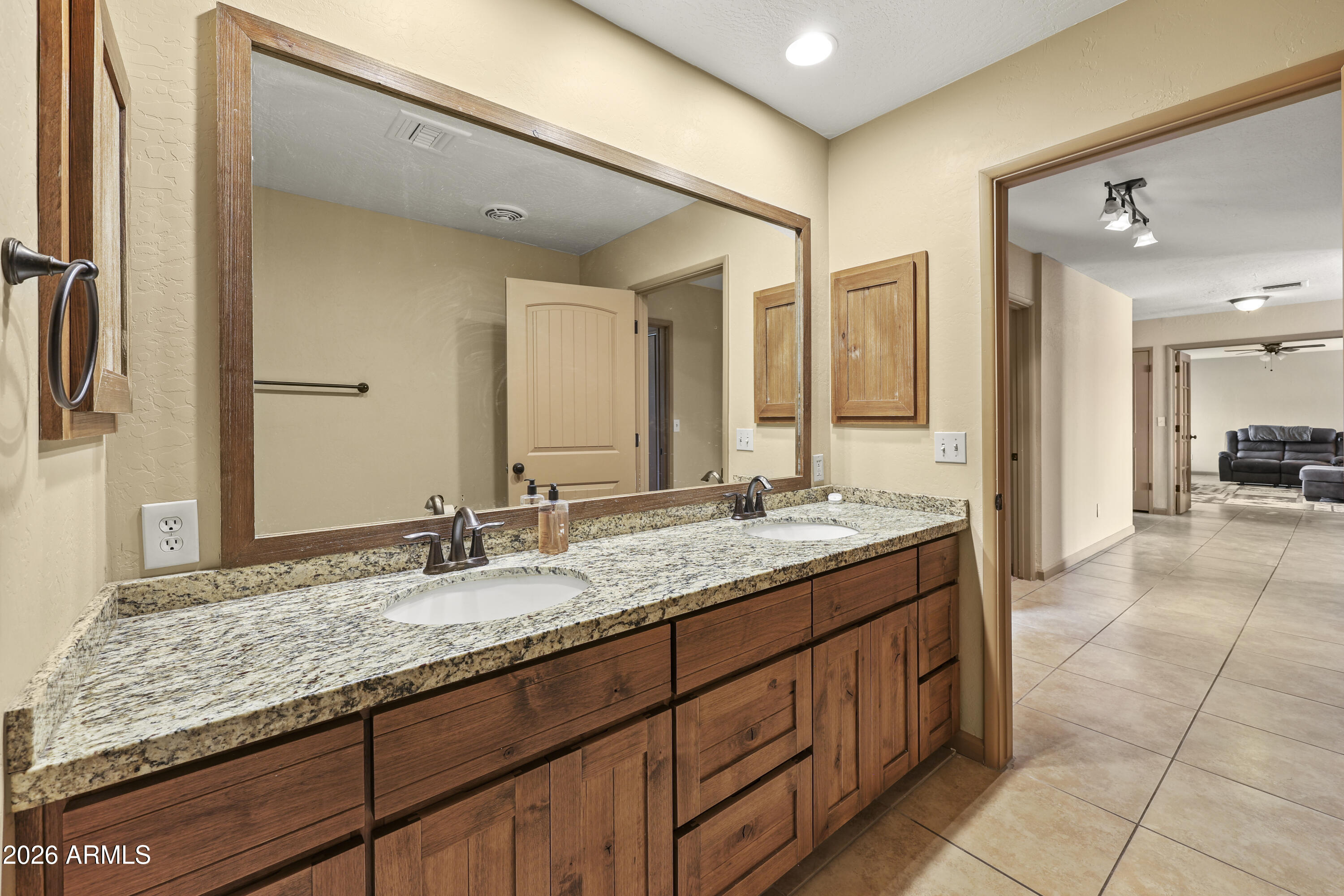 1890 West Roderick Lane Wickenburg, AZ 85390 - Photo 32 of 41 a bathroom with a granite countertop sink and a mirror