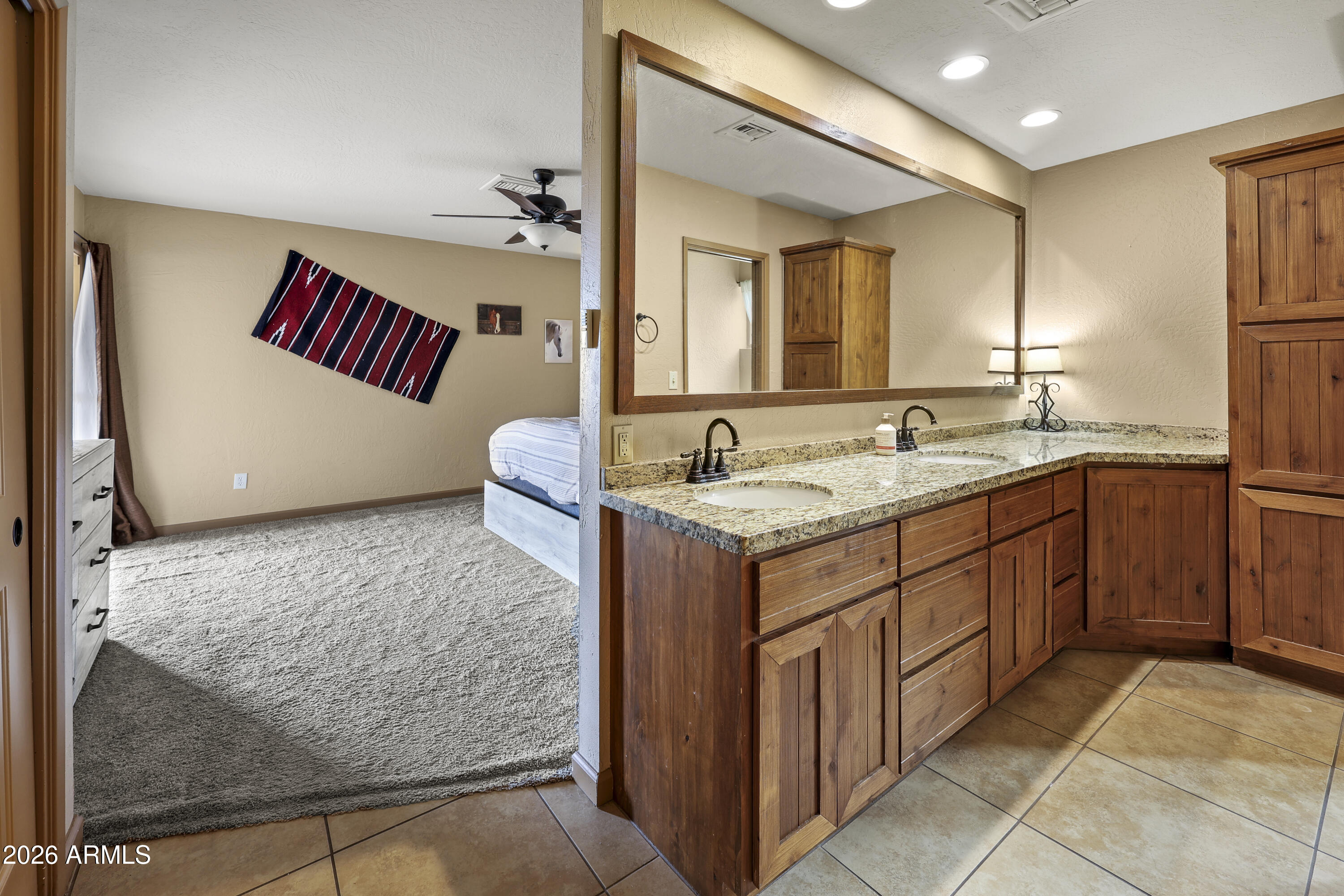 1890 West Roderick Lane Wickenburg, AZ 85390 - Photo 5 of 41 a bathroom with a granite countertop sink and a mirror