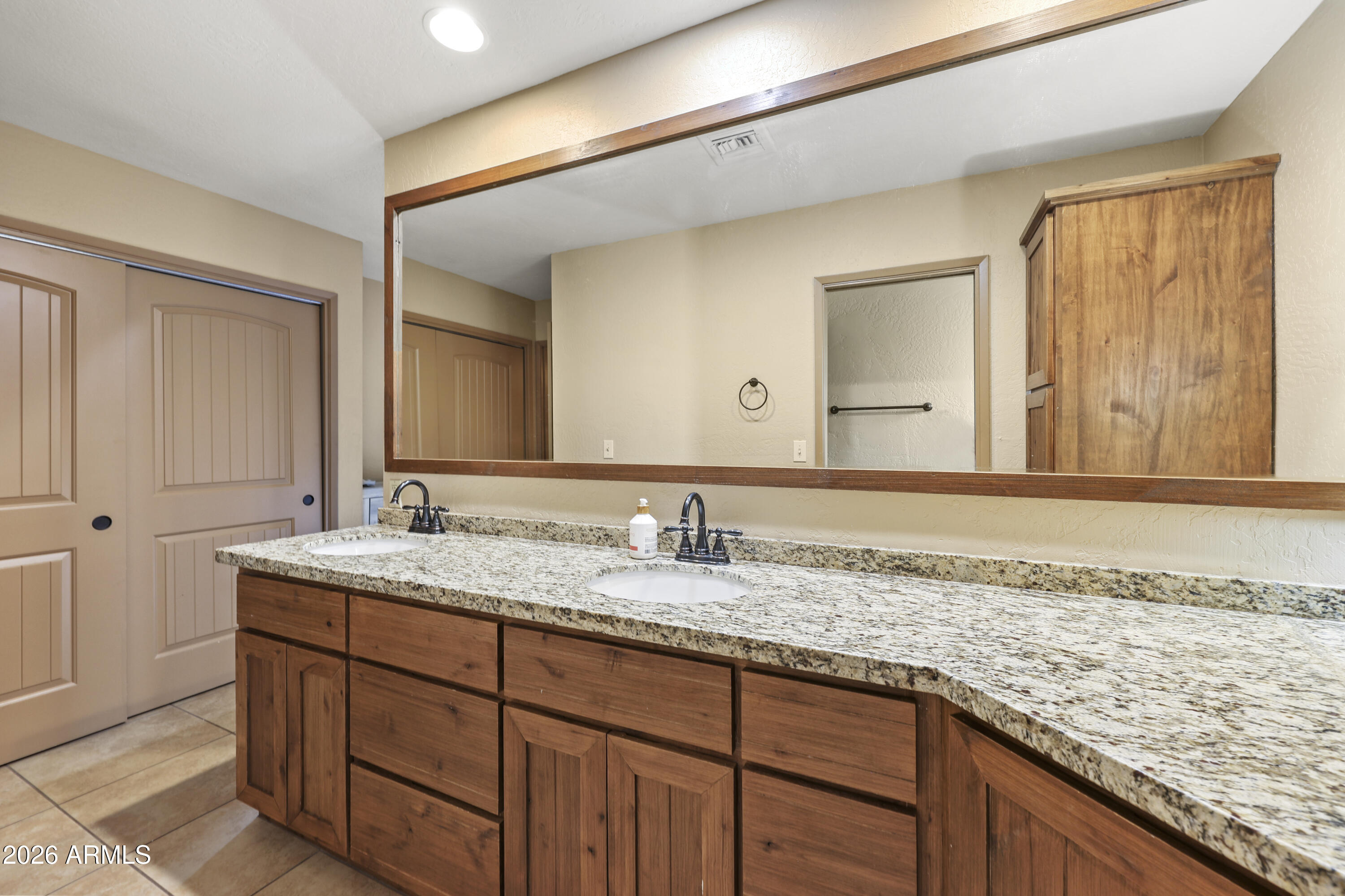 1890 West Roderick Lane Wickenburg, AZ 85390 - Photo 6 of 41 a bathroom with a granite countertop sink and a mirror