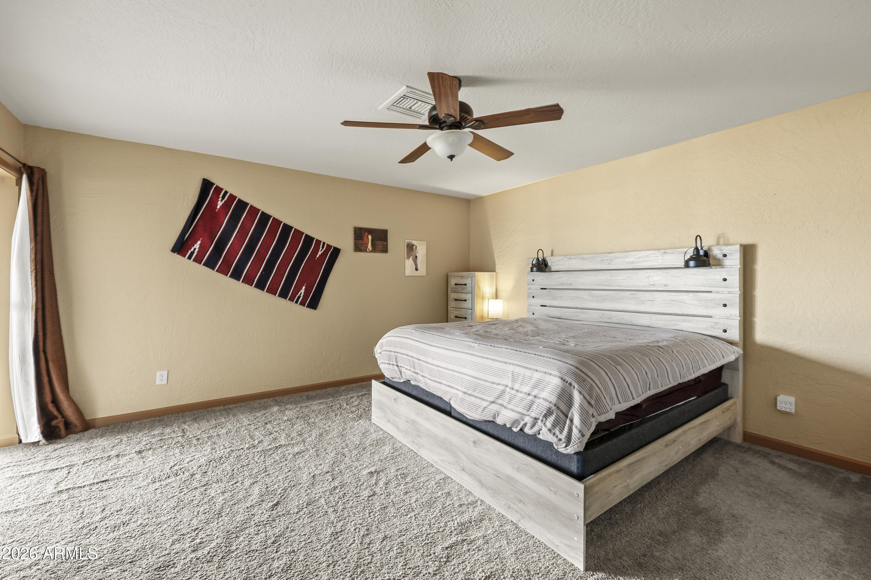1890 West Roderick Lane Wickenburg, AZ 85390 - Photo 7 of 41 a bedroom with a bed and window