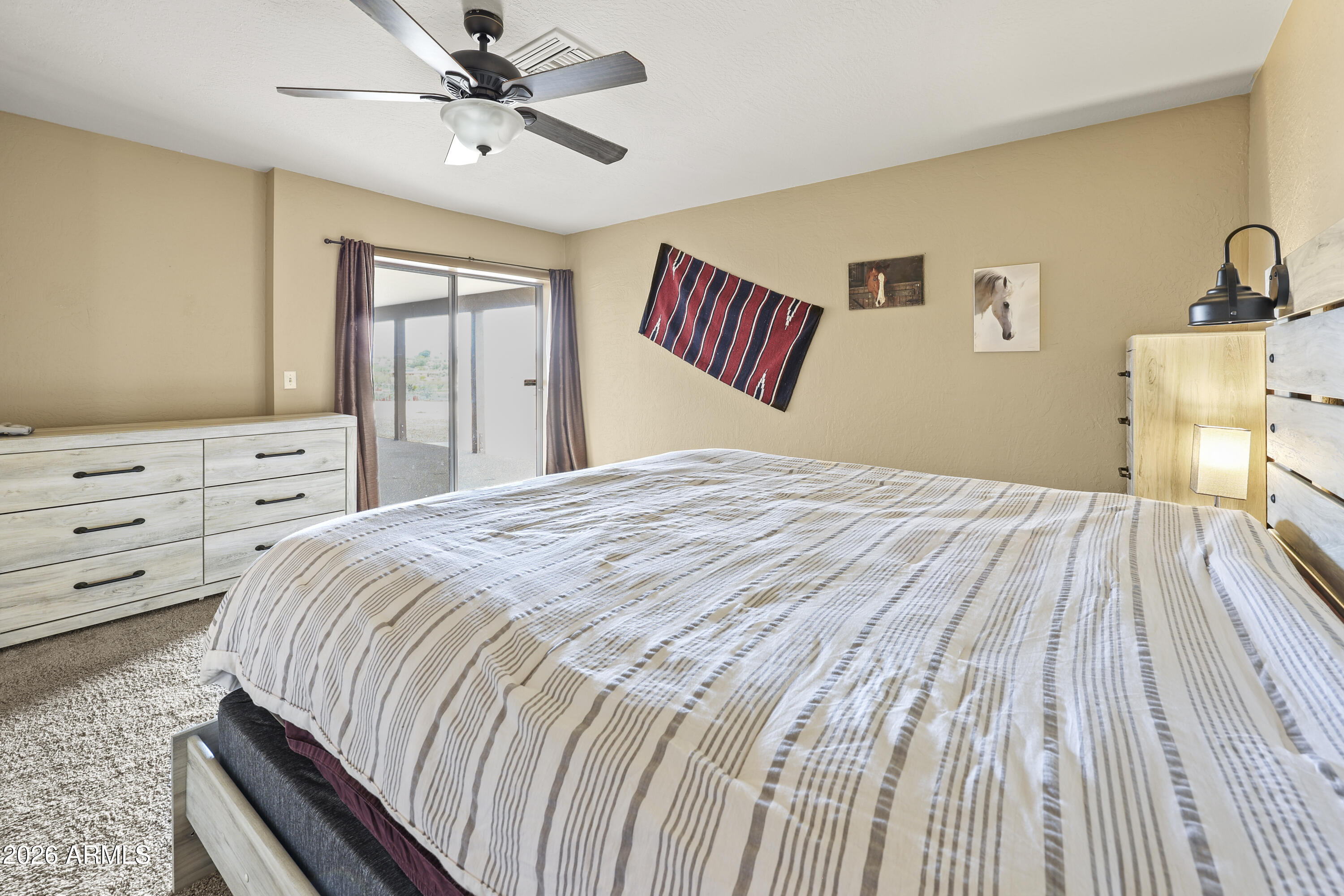 1890 West Roderick Lane Wickenburg, AZ 85390 - Photo 8 of 41 a bedroom with a bed and a dresser