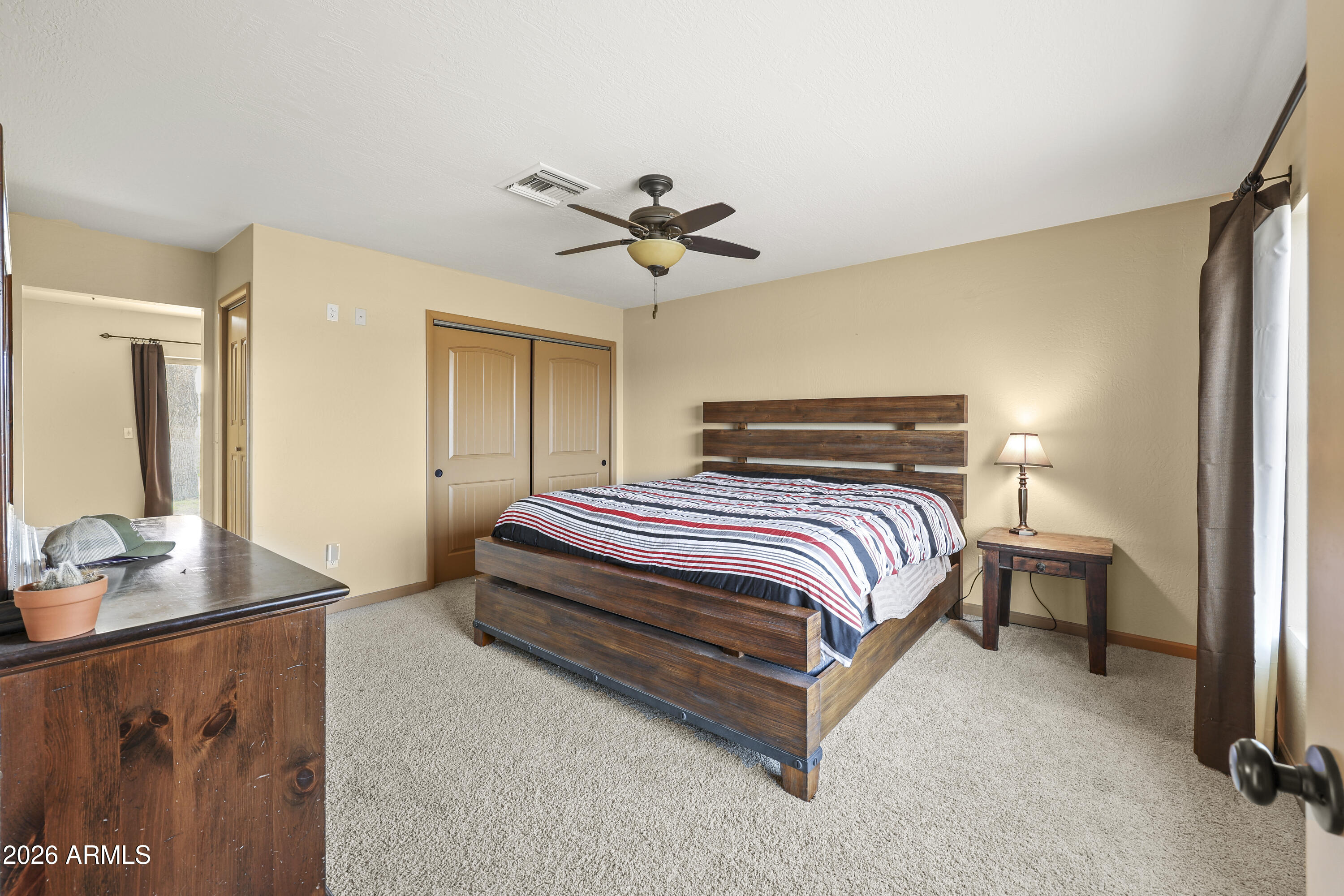 1890 West Roderick Lane Wickenburg, AZ 85390 - Photo 10 of 41 a bedroom with a bed and a chandelier