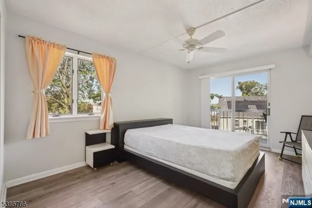 a bedroom with a bed a table and a large window