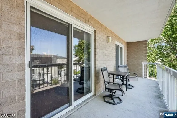 a view of balcony with two chairs and a potted plant