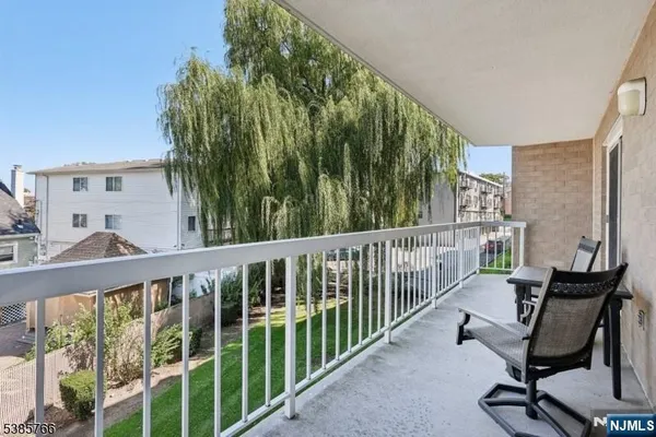 a view of a balcony with chair and wooden fence