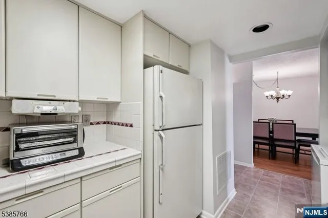 a kitchen with a refrigerator and cabinets
