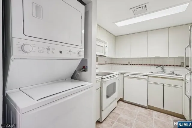 a view of washer and dryer with kitchen countertops