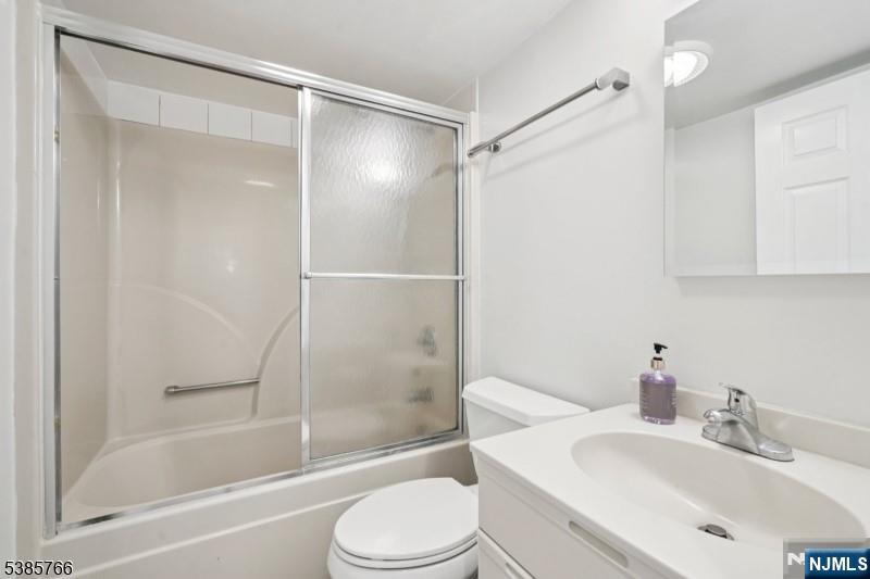 38 Moonachie Road, Unit 116 Hackensack, NJ 07601 - Photo 7 of 19 a bathroom with a bathtub shower sink vanity and toilet