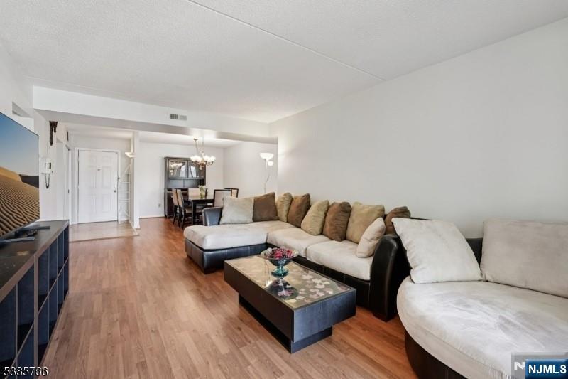 38 Moonachie Road, Unit 116 Hackensack, NJ 07601 - Photo 9 of 19 a living room with furniture and a wooden floor
