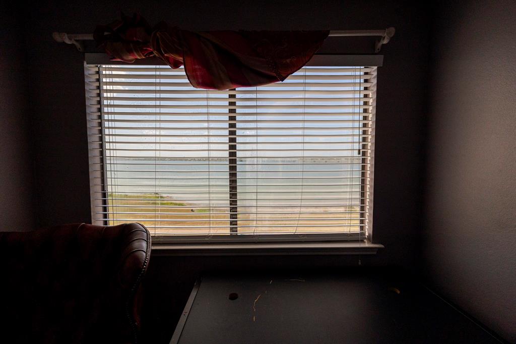 1418 Signal Ridge Place Rockwall, TX 75032 - Photo 16 of 35 Window with horizontal blinds overlooking a body of water and distant shoreline