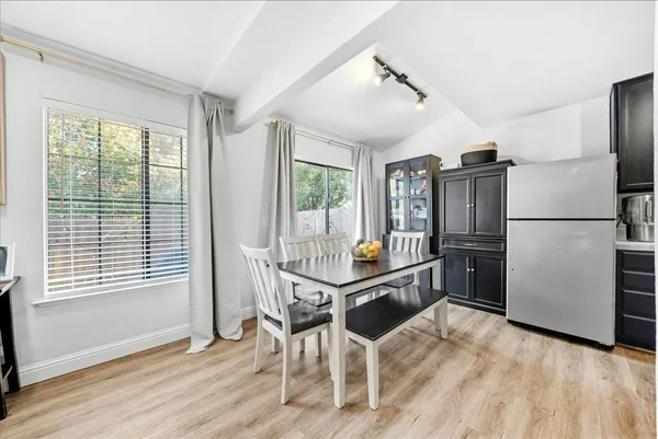 a kitchen with granite countertop a refrigerator stove top oven and sink