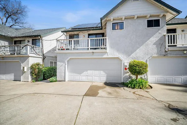 a front view of a house with a yard and a garage
