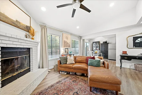 a view of a dining room with furniture a kitchen and chandelier