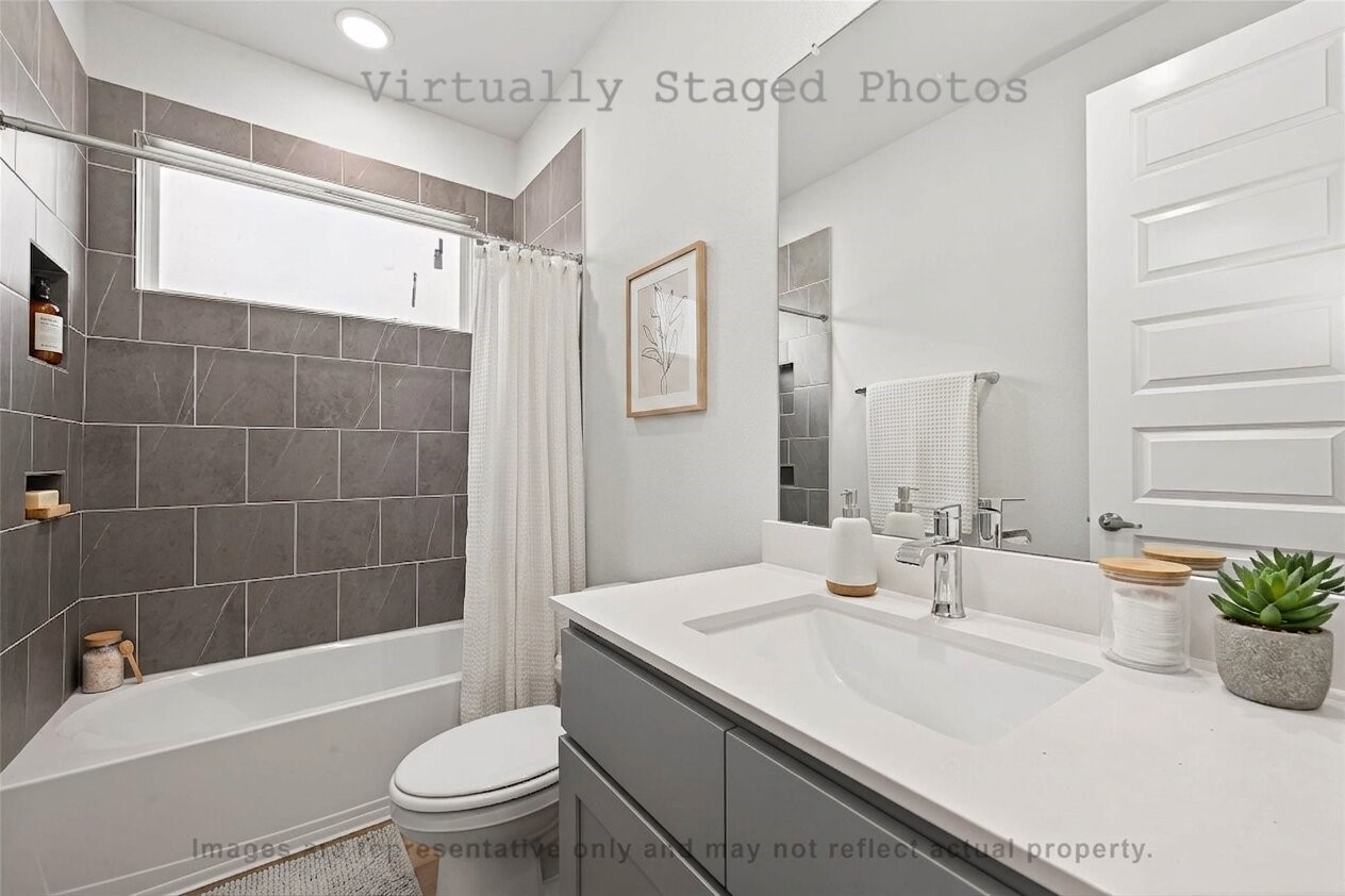 10719 Mason Road, Unit 26 Richmond, TX 77406 - Photo 8 of 50 Virtual Staging - Modern bathroom features a sleek gray vanity, a matching gray-tiled shower, and minimalist neutral decor