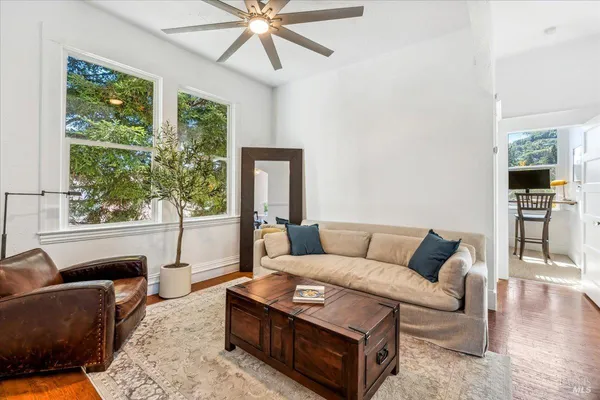 a living room with furniture and wooden floor