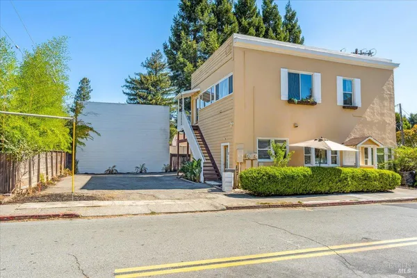 a view of house with outdoor space and parking
