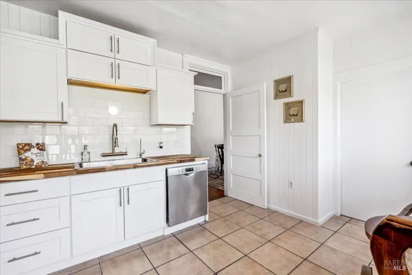 a kitchen with a sink cabinets and window
