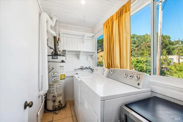 a kitchen with granite countertop a sink stove and refrigerator