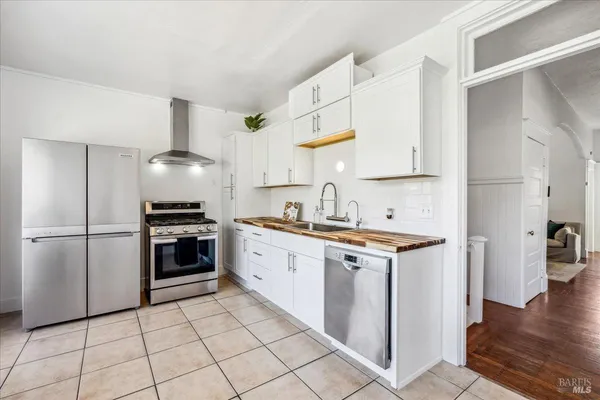 a kitchen with cabinets stainless steel appliances and sink